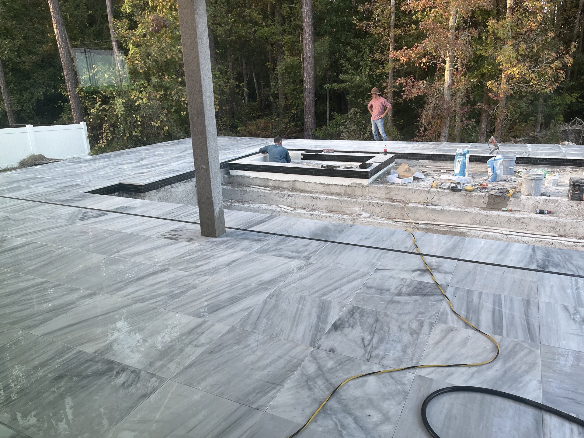 Early construction progress in the Mandarin backyard around the pool and covered outdoor area.
