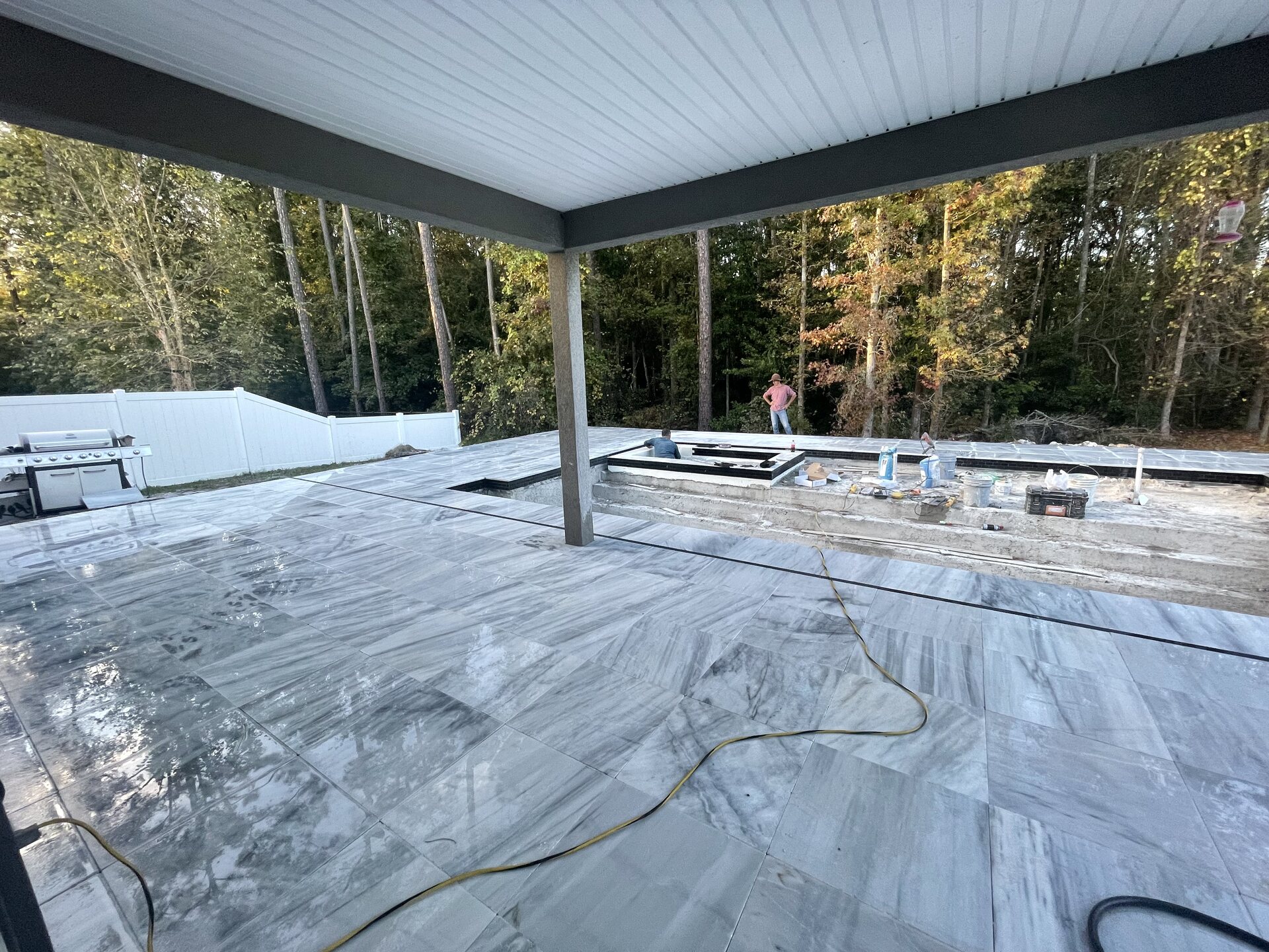 Second view of the pool and backyard during construction.