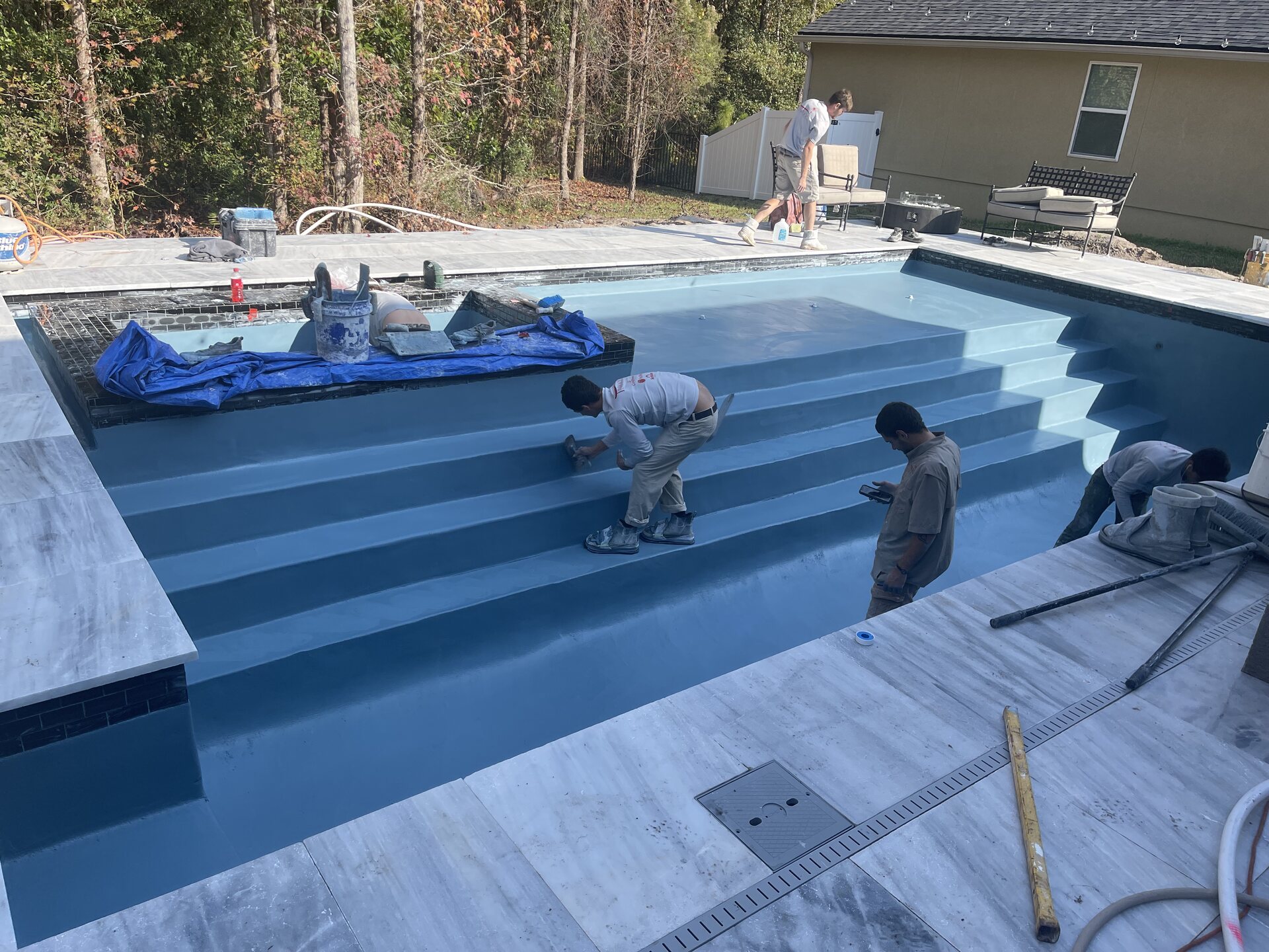 View of the pool and surrounding hardscape during the Mandarin project build.